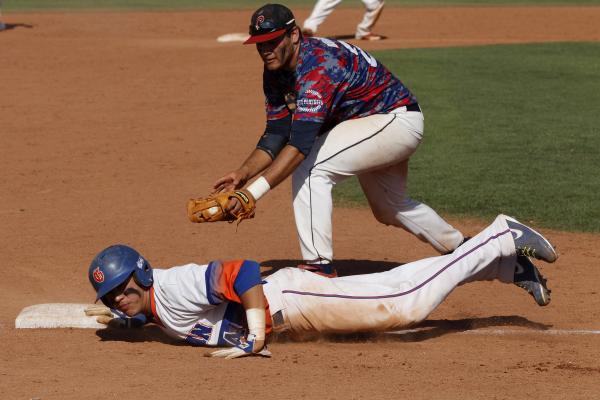 Bishop Gorman’s Jerrel Latham slides safely back into third base under the tage of Jul ...