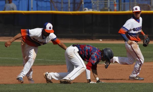 Bishop Gorman’s Kai Domingo, left, tags out Coronado’s Cain Brady during the fir ...