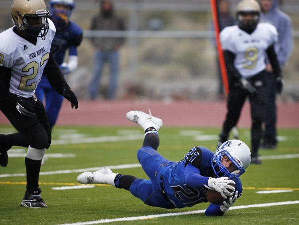 Pahranagat Valley’s Jordan Cryts dives with the ball as Spring Mountain’s Arias ...