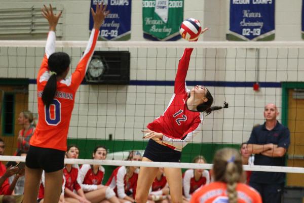 Coronado’s Brooke Garlick (12) tries to hit around the block of Bishop Gorman’s ...