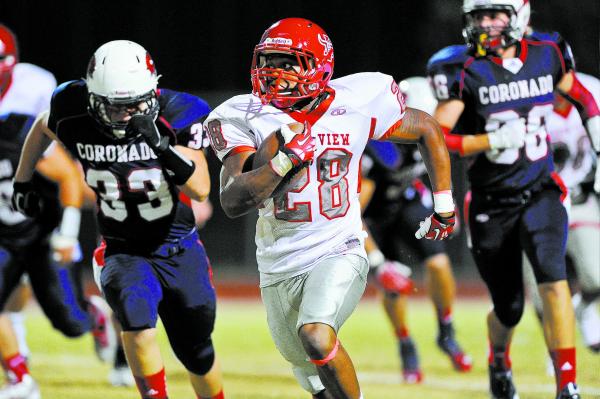 Arbor View running back Jacob Speaks (28) races past Coronado defender Joseph Gardner (33) o ...