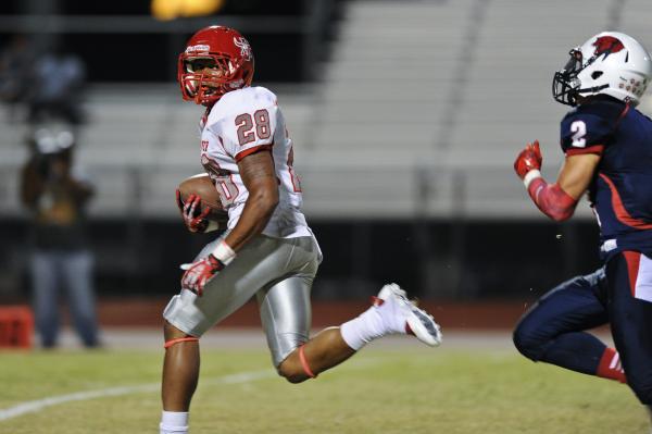 Arbor View running back Jacob Speaks (28) looks back at Coronado defender Wade Jacobs (2) du ...