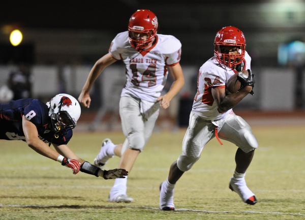 Arbor View running back Herman Gray (28) runs past Coronado defender Andrew Decker (8) durin ...