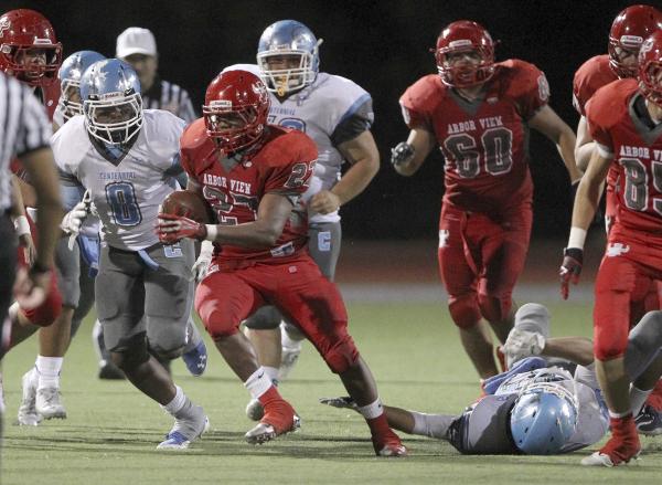 Arbor View fullback Denajiou McZeal runs ahead of Centennial defender Haikeem Arnold in the ...