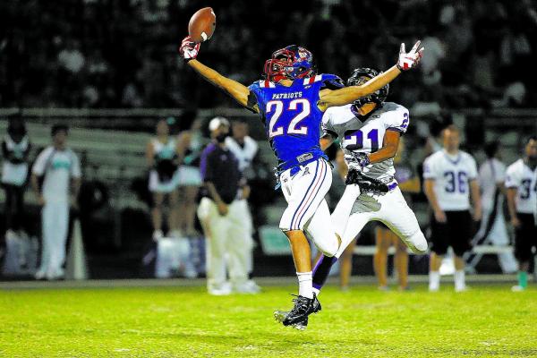 Liberty’s Deseon McQuaig (22) jumps to catch a pass over Silverado’s Daniel Sava ...