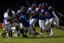 Liberty linebacker Ethan Tuilagi takes down Silverado’s Braden Weaver (35) during Libe ...