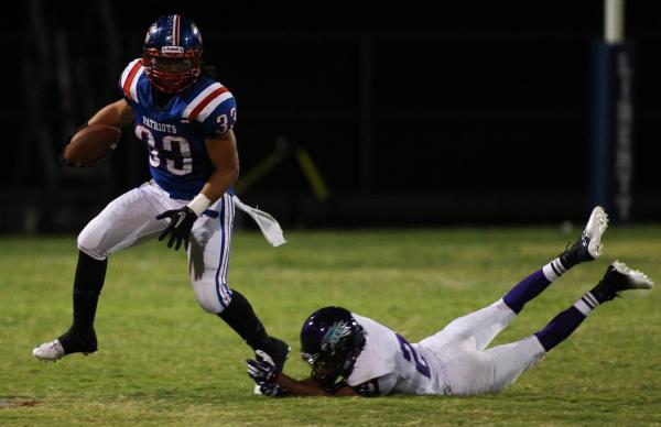 Liberty’s Brenan Adams (33) eludes Silverado’s Daniel Savage (21) during the Pat ...