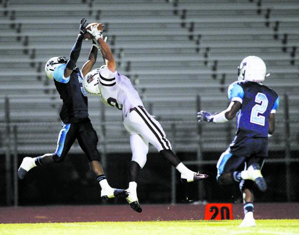 Canyon Springs’ A.J. Cooper (3) breaks up a pass intended for Desert Oasis’ Gary ...