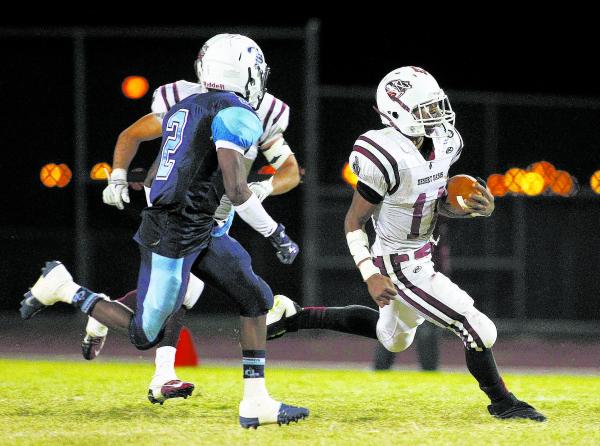 Desert Oasis running back Jocquez Kalili, racing past Canyon Springs safety Raequan Bascombe ...