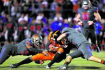 Bishop Gorman’s Dylan Weldon (30) and Nico Fertitta (4) converge on Booker T. Washingt ...