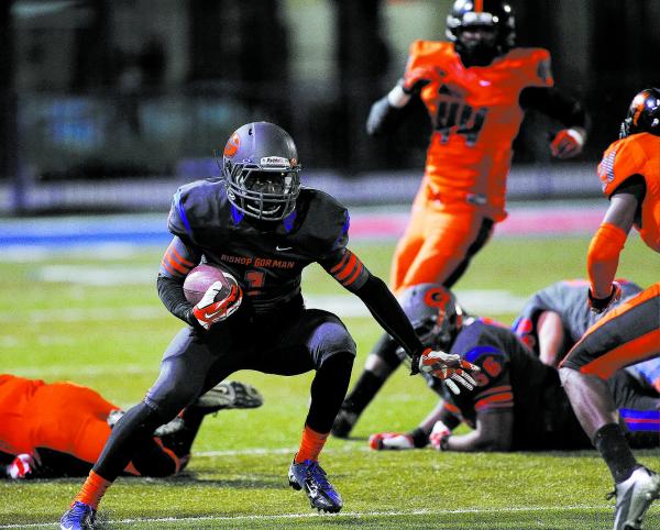 Bishop Gorman’s Daniel Stewart (1) looks for running room against Booker T. Washington ...