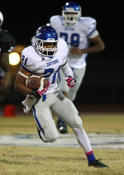 Green Valley’s Larry Norman carries the ball on Thursdy at Canyon Springs. Norman rush ...