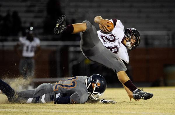 Cimarron-Memorial’s Michael Barnson (28) fights for extra yardage on Friday. Legacy he ...