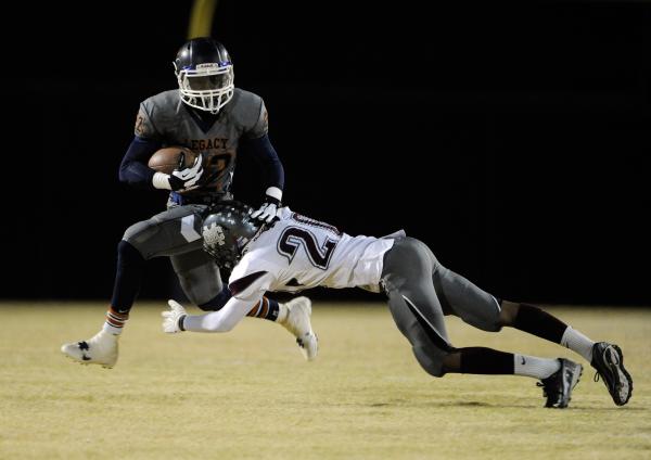 Cimarron-Memorial’s Savigon McIver, right, tries to take down Legacy’s DeMichael ...