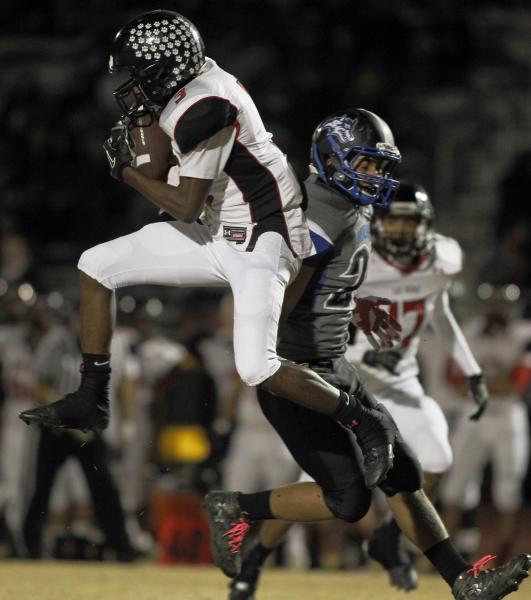 Las Vegas’ Jordan Jones (3) intercepts a pass on Friday against Basic.