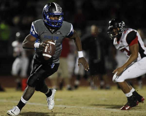 Basic quarterback Antraye Johnson (5) breaks free against Las Vegas on Friday night. Johnson ...