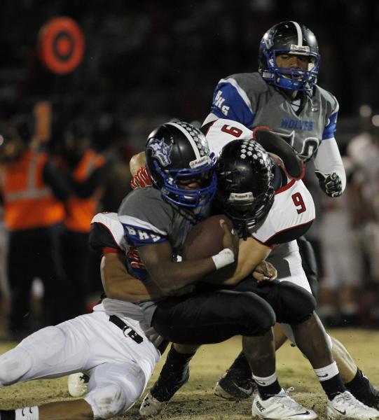 Las Vegas’ Ryan Magante (53) and Jacob Anderson (9) sack Basic quarterback Antraye Joh ...