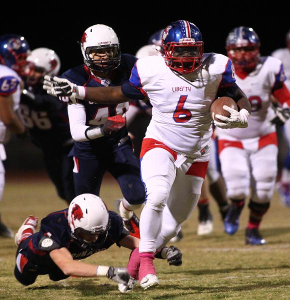 Liberty’s Calvin Tubbs (6) runs through the Coronado defense on Friday. Tubbs rushed f ...