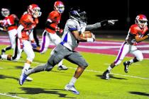 Desert Pines Tim Hough (4) points to the end zone in route to a 32-yard touchdown score agai ...