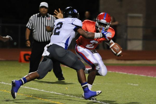 Valley quarterback Tyrone Prewitt (2) scrambles away from Desert Pines defender Eric Wilkes ...