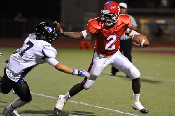 Valley quarterback Tyrone Prewitt (2) breaks free from Desert Pines defender Ryan Naki-Pooma ...