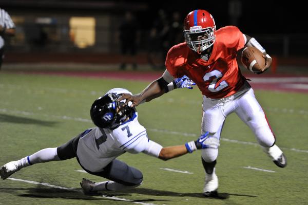 Valley quarterback Tyrone Prewitt (2) breaks free from Desert Pines defender Ryan Naki-Pooma ...