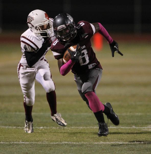 Cimarron-Memorial wide receiver Maurice Bennett runs ahead of Desert Oasis defensive back Hu ...