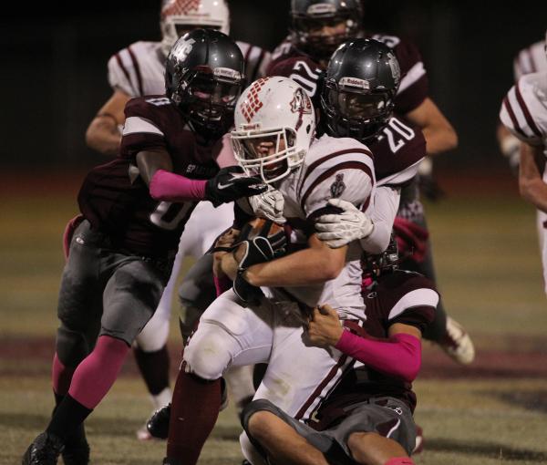 Desert Oasis fullback Blake Kutz drags a host of Cimarron-Memorial players for extra yards o ...