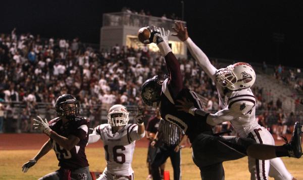 Cimarron-Memorial tight end Dallin Breen reaches for a pass as Desert Oasis defensive back Q ...