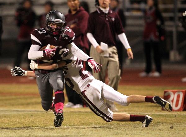 Cimarron-Memorial wide receiver Djon Watson tries to break away from Desert Oasis defensive ...