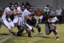 Legacy running back DeMichael Walker (22) runs past a host of Hurricane defenders on Saturda ...