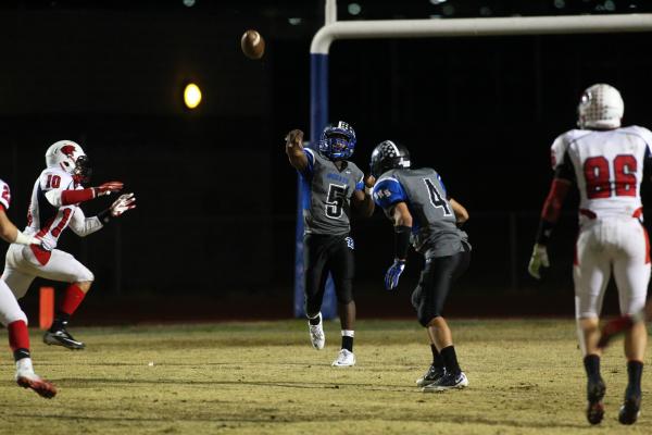 Basic’s Antraye Johnson throws a pass on Friday against Coronado. Johnson ran for two ...