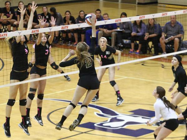 Palo Verde outside hitter Lexi Riggs (2) hits the ball past Bishop Gorman’s Emma Kirst (9) ...