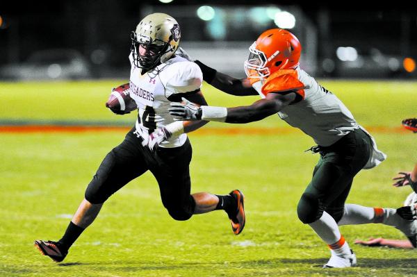 Faith Lutheran’s Fabian Lagudi (44) tries to elude Mojave’s Elijah Smoot (3) on ...