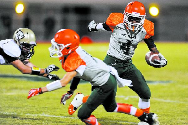 Mojave’s Davion Fletcher (4) looks for running room on Friday against Faith Lutheran.