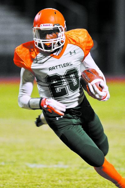 Mojave’s Eric Snyder (20) carries the ball on Friday against Faith Lutheran. 