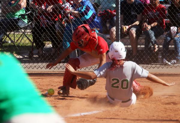 Green Valley’s Brandie Beverly slides home safely as Las Vegas catcher Kali Brockett a ...