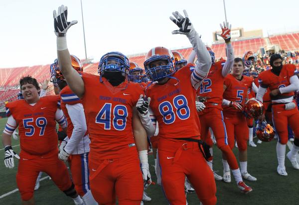 Bishop Gorman’s Chris Lalli (48) and James Huber (88) celebrate their school’s f ...