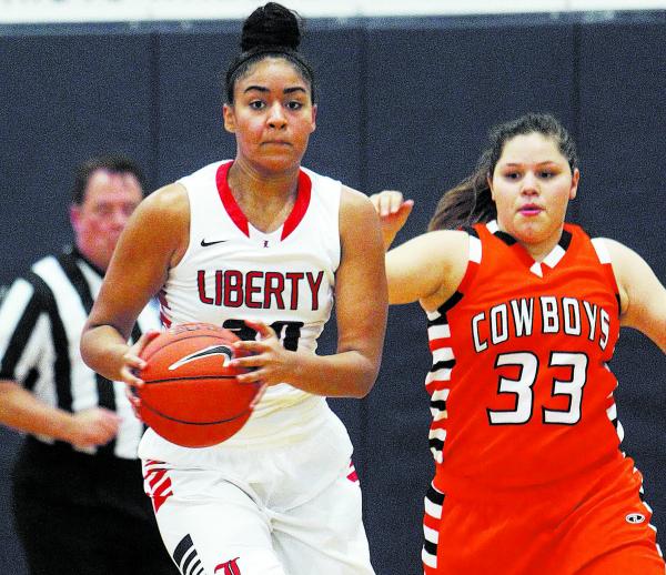 Liberty’s Paris Strawther (30) brings the ball down court while being guarded by Chapa ...