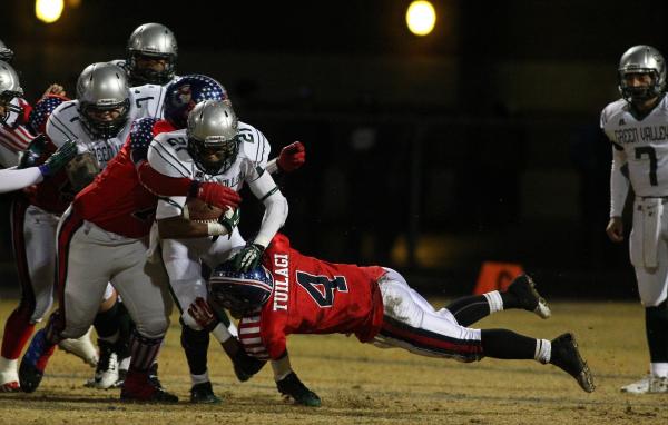 Green Valley’s Larry Norman tries to break a tackle by Liberty’s Ethan Tuilagi ( ...