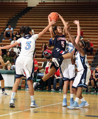 Coronado’s Ashley Johnson (5) drives the lane defended by Canyon Springs’ Cheris ...