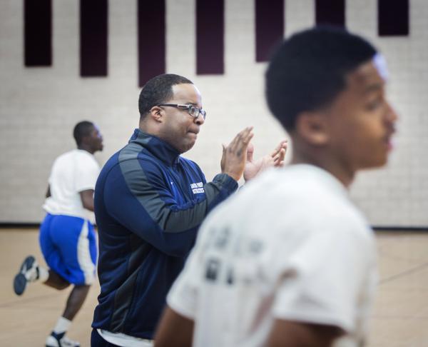 Agassi Prep basketball coach Trevor Diggs encourages playes during practice on Monday.