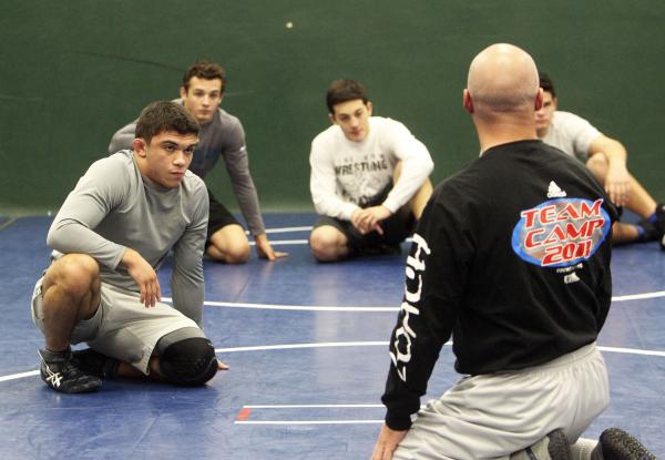 Green Valley wrestler Donovan Peek, left, listens to instructions from coach Jon Ferry durin ...