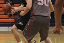 Valley High’s Spencer Mathis, left, looks to pass around Wisconsin Swings’ Parke ...