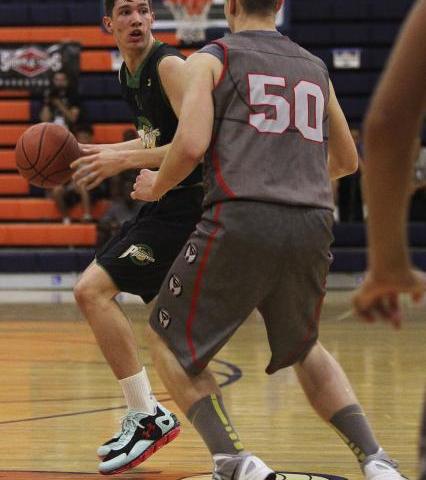 Valley High’s Spencer Mathis, left, looks to pass around Wisconsin Swings’ Parke ...