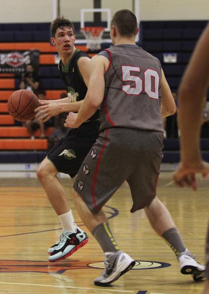 Valley High’s Spencer Mathis, left, looks to pass around Wisconsin Swings’ Parke ...