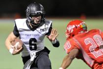 Palo Verde quarterback Parker Rost (6) evades incoming Arbor View defender Jacob Speaks (28) ...