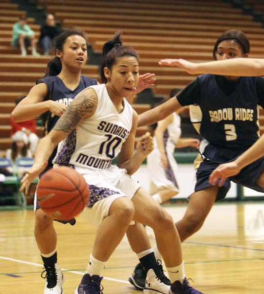 Sunrise Mountain’s Brittany Veal (10) tries to slip past Shadow Ridge’s Michelle ...