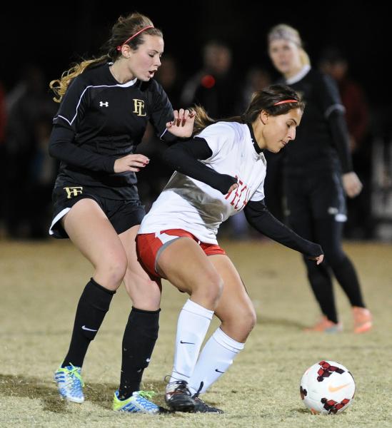 Tech’s Alex Guzman shields the ball from Faith Lutheran’s Emily Neighbors during ...