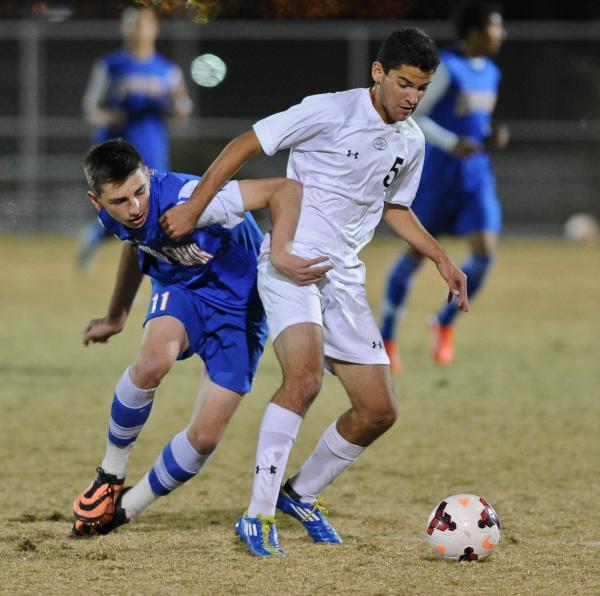 Bishop Gorman’s Tristan Blackmon (11) battles with Palo Verde’s Jose Ahumada (5) ...